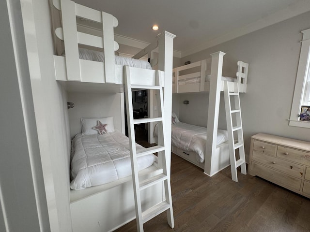 bedroom featuring dark wood finished floors and crown molding