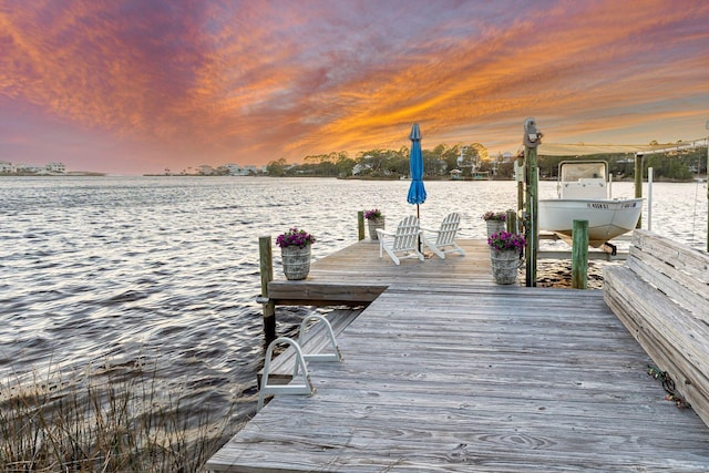 dock area with boat lift and a water view