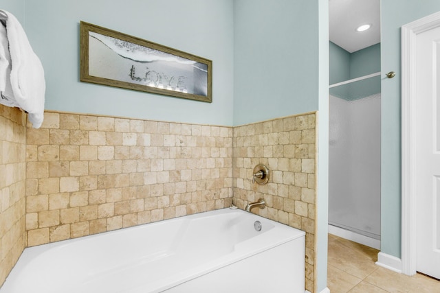 full bath with a shower stall, a bath, and tile patterned floors