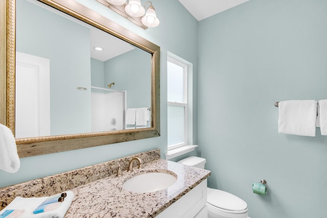 full bathroom with vanity, toilet, and a shower stall