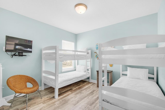 bedroom with wood finished floors and baseboards