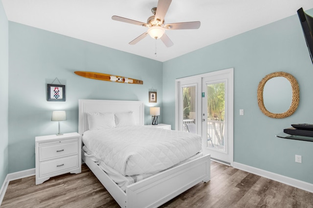 bedroom with access to outside, baseboards, and wood finished floors