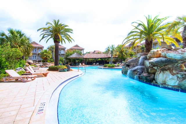 community pool with a patio area and a gazebo