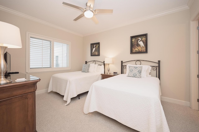 bedroom featuring carpet flooring, crown molding, baseboards, and ceiling fan