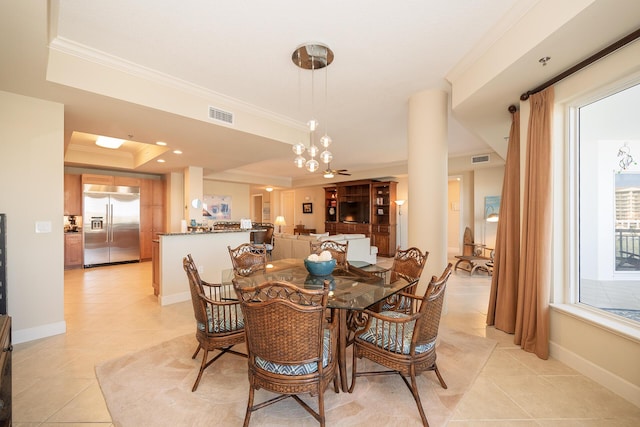 dining area featuring a tray ceiling, crown molding, light tile patterned floors, visible vents, and baseboards