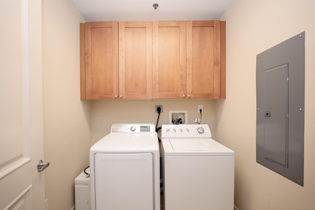 laundry area with washer and dryer, electric panel, and cabinet space