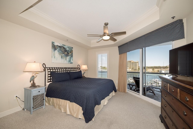 bedroom featuring light carpet, baseboards, ceiling fan, a tray ceiling, and crown molding