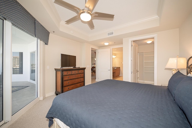 bedroom with ornamental molding, a raised ceiling, and light carpet