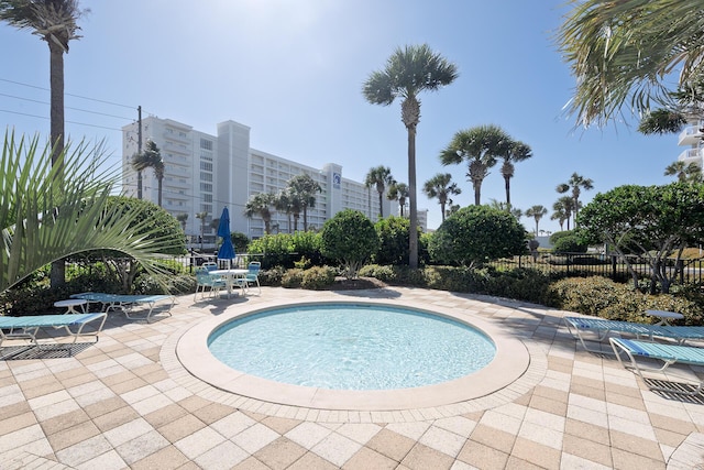 view of pool with a patio and fence