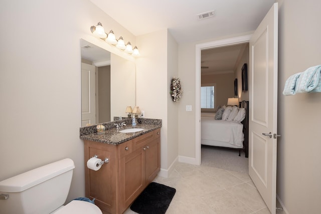 ensuite bathroom featuring ensuite bathroom, toilet, vanity, visible vents, and tile patterned floors