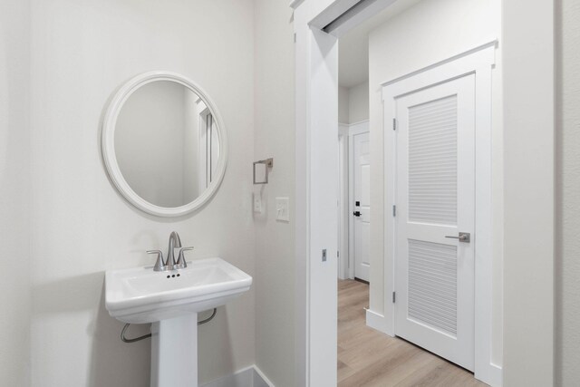 bathroom featuring baseboards and wood finished floors