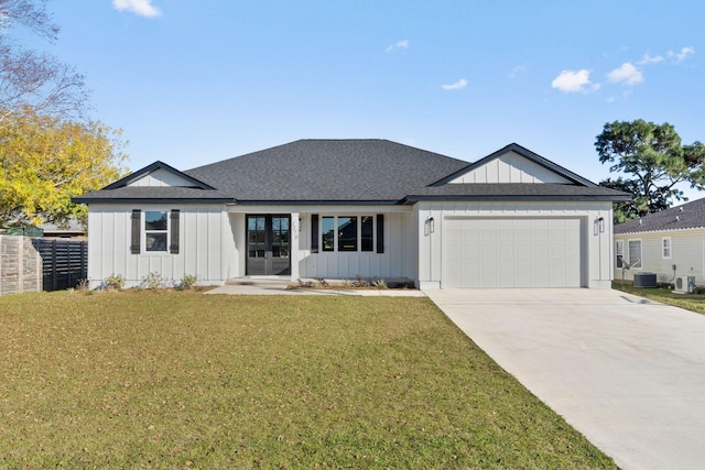 view of front of home with central air condition unit, concrete driveway, an attached garage, board and batten siding, and a front lawn