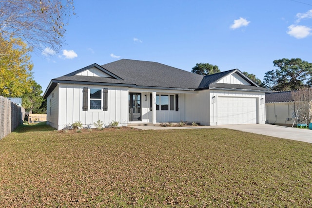 ranch-style home featuring an attached garage, a front lawn, board and batten siding, and concrete driveway