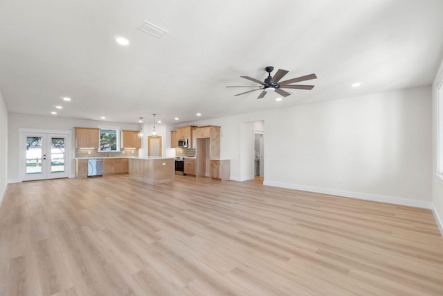 unfurnished living room featuring light wood finished floors, recessed lighting, and baseboards