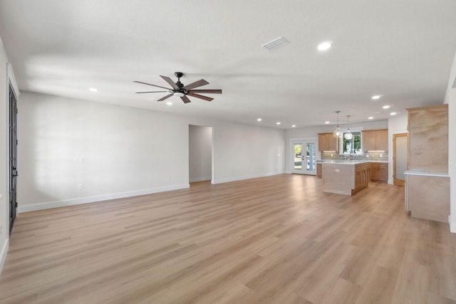 unfurnished living room with a ceiling fan, recessed lighting, light wood-style flooring, and baseboards