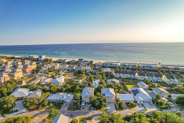 birds eye view of property with a water view, a residential view, and a beach view