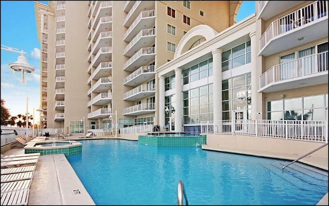 view of swimming pool featuring a community hot tub