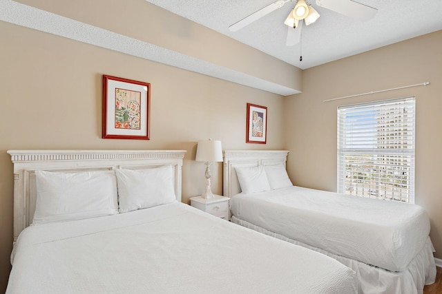 bedroom with ceiling fan and a textured ceiling