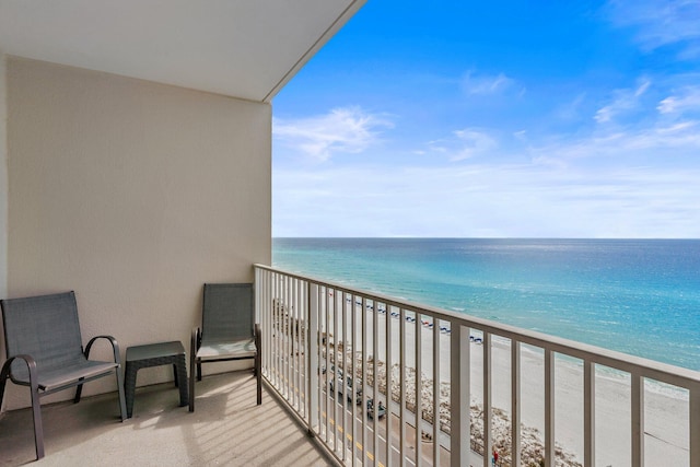 balcony featuring a water view and a beach view