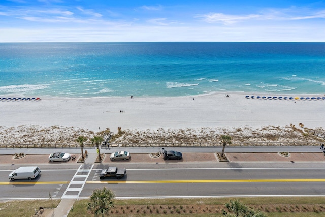 bird's eye view featuring a water view and a beach view