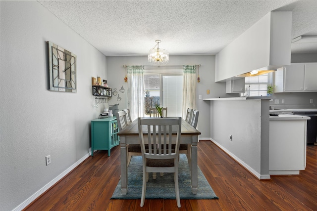 dining space featuring a chandelier, a healthy amount of sunlight, and dark wood finished floors