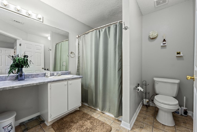 bathroom featuring visible vents, a textured ceiling, toilet, and vanity