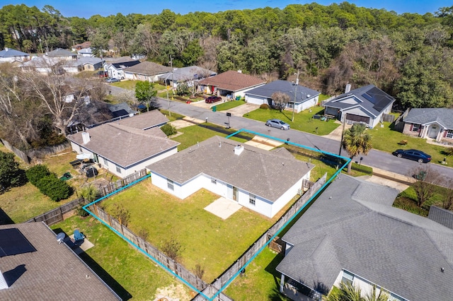 drone / aerial view with a residential view and a view of trees