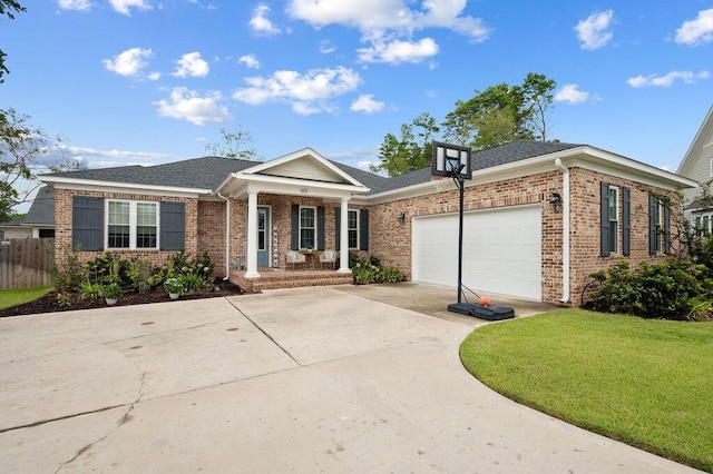 view of front facade with brick siding, an attached garage, a front yard, fence, and driveway