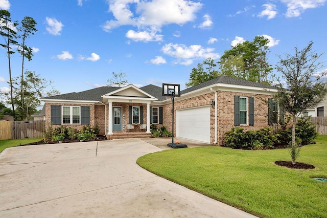 view of front of property with concrete driveway, brick siding, a front yard, and fence