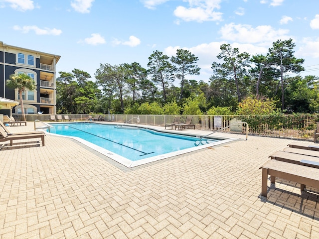 pool featuring a patio area and fence