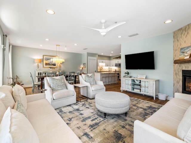 living room featuring recessed lighting, a fireplace, wood finished floors, a ceiling fan, and visible vents