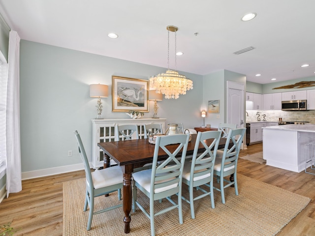 dining space with recessed lighting, baseboards, visible vents, and light wood finished floors