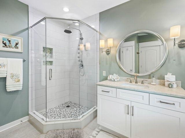 bathroom featuring a stall shower, recessed lighting, vanity, and baseboards