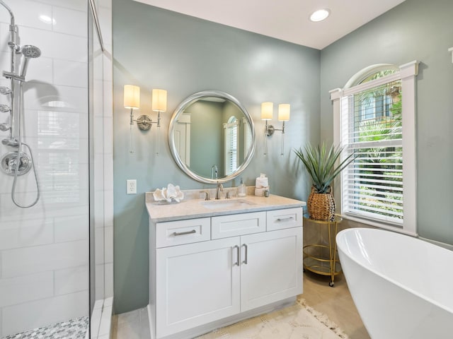 full bath featuring a stall shower, recessed lighting, a freestanding bath, and vanity