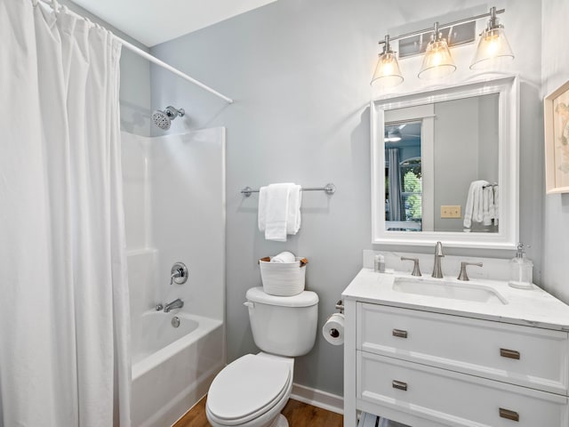 full bathroom with toilet, wood finished floors, vanity, baseboards, and shower / bath combo