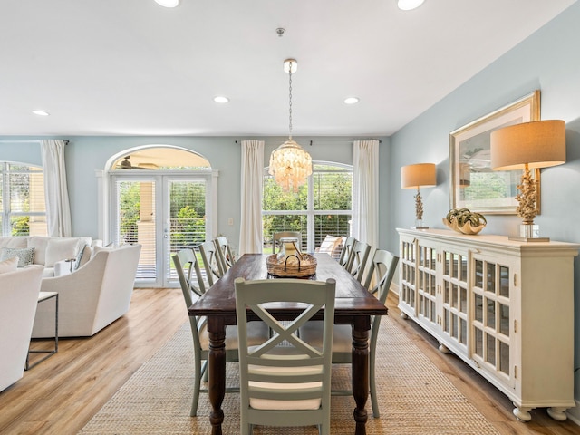 dining area with a chandelier, recessed lighting, plenty of natural light, and wood finished floors