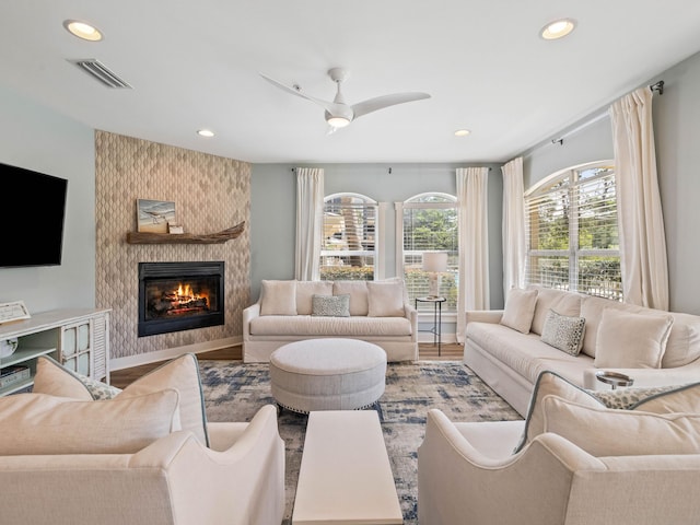 living area with visible vents, ceiling fan, wood finished floors, a fireplace, and recessed lighting