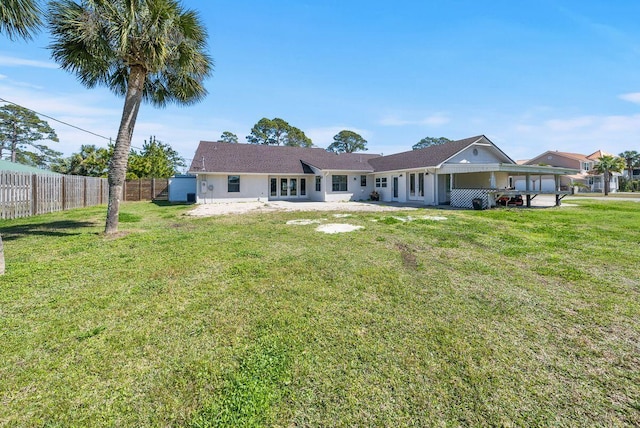 back of property featuring fence private yard, a patio area, and a lawn