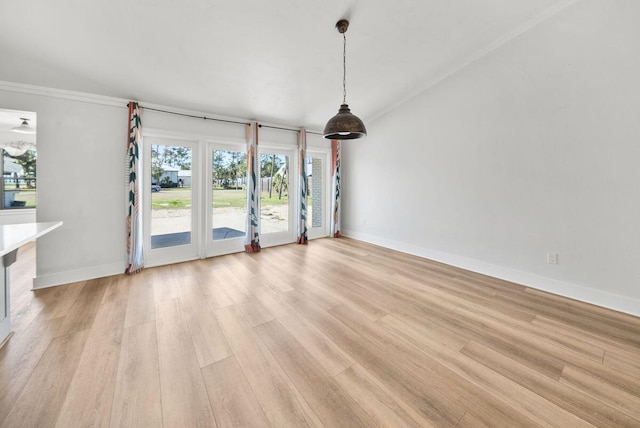 unfurnished living room with light wood-style flooring and baseboards