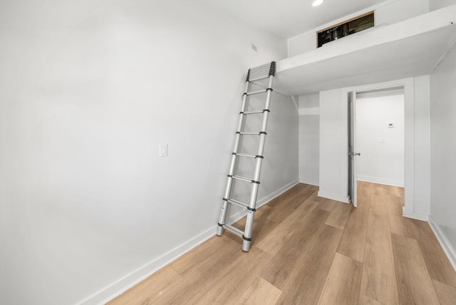 spare room featuring light wood-style flooring and baseboards