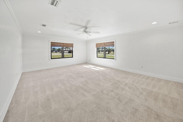 unfurnished room with baseboards, carpet, visible vents, and crown molding