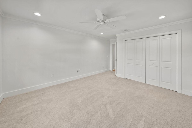 unfurnished bedroom with carpet flooring, crown molding, and baseboards