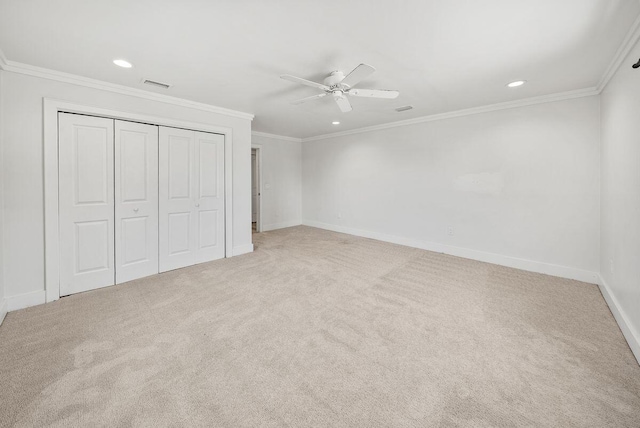 unfurnished bedroom with ornamental molding, carpet, visible vents, and baseboards