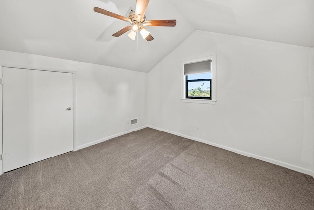 bonus room with vaulted ceiling, ceiling fan, carpet flooring, and baseboards