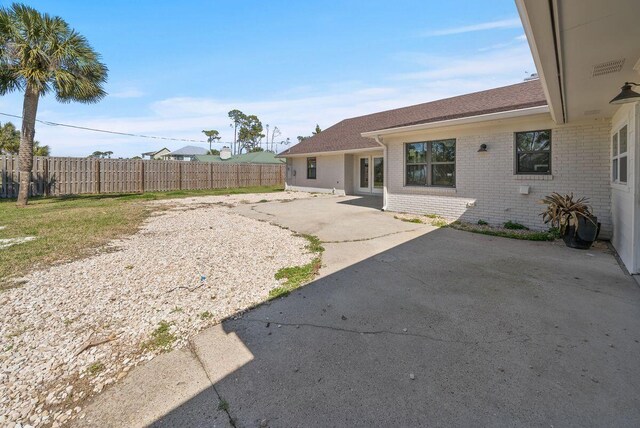 view of yard with fence and a patio