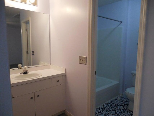 full bathroom featuring toilet, bathing tub / shower combination, vanity, and tile patterned floors