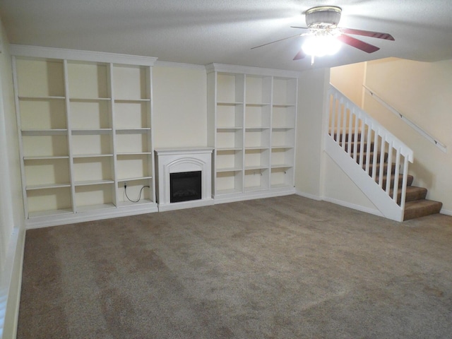 946 Ashley Ln Unit C, Fort Walton Beach, FL 32547 - unfurnished living room featuring ceiling fan, carpet floors, a fireplace, built in shelves, and stairway