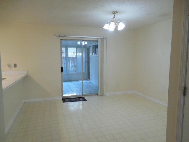 946 Ashley Ln Unit C, Fort Walton Beach, FL 32547 - empty room featuring a chandelier, tile patterned floors, and baseboards