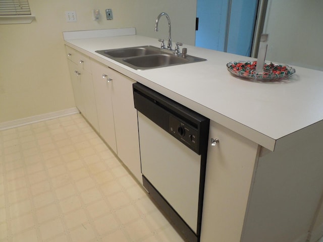 946 Ashley Ln Unit C, Fort Walton Beach, FL 32547 - kitchen featuring white dishwasher, a sink, light floors, light countertops, and white cabinetry