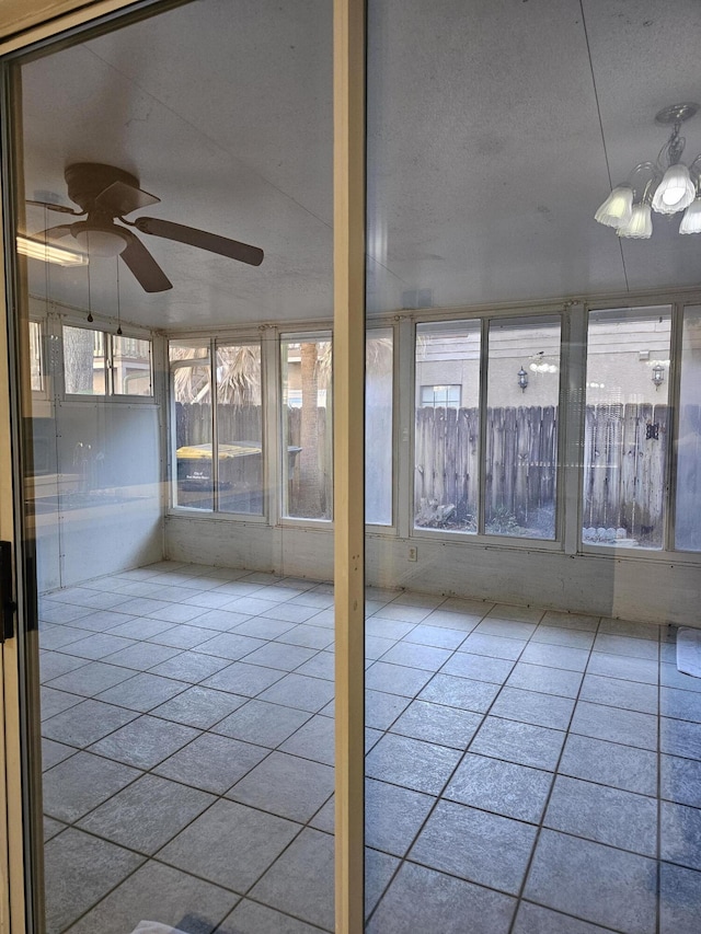 946 Ashley Ln Unit C, Fort Walton Beach, FL 32547 - unfurnished sunroom featuring ceiling fan, tile patterned floors, and a textured ceiling